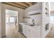 Stylish wet bar with white cabinetry, quartz countertop, and a wine cooler at 5750 Edna Ave, Las Vegas, NV 89146