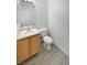 Clean bathroom, featuring a toilet and sink with wood cabinets at 5965 Palmilla St # 2, North Las Vegas, NV 89031