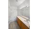 Bathroom with a bathtub, sink and wood cabinets at 5965 Palmilla St # 2, North Las Vegas, NV 89031