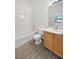 Clean bathroom, featuring a tub, toilet and wood cabinets at 5965 Palmilla St # 2, North Las Vegas, NV 89031