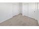 Spacious bedroom with neutral carpeting and ample closet space at 5965 Palmilla St # 2, North Las Vegas, NV 89031