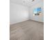 Bright bedroom with neutral carpeting and large window at 5965 Palmilla St # 2, North Las Vegas, NV 89031