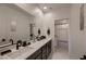 Modern bathroom features double sinks with sleek fixtures, large mirrors, and a stylish shower with a black-and-white theme at 6289 Redstone Hills Dr, Las Vegas, NV 89148