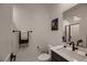 Modern bathroom featuring sleek vanity, decorative art and luxurious tile flooring at 6289 Redstone Hills Dr, Las Vegas, NV 89148