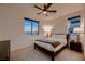 Comfortable bedroom featuring large windows with scenic views and a ceiling fan at 6289 Redstone Hills Dr, Las Vegas, NV 89148
