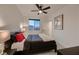 Well-lit bedroom with plush carpeting, a large window, neutral walls, and a ceiling fan for added comfort at 6289 Redstone Hills Dr, Las Vegas, NV 89148