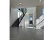 Bright entryway featuring staircase, light gray wood floors, and white walls at 6289 Redstone Hills Dr, Las Vegas, NV 89148