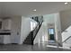 Bright entryway boasts a staircase with modern black railing and leads into an open floor plan at 6289 Redstone Hills Dr, Las Vegas, NV 89148
