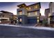 Modern home featuring a two-car garage, contemporary design and manicured front yard at 6289 Redstone Hills Dr, Las Vegas, NV 89148