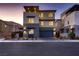 Contemporary home with a two-car garage, desert landscaping, and modern design elements at 6289 Redstone Hills Dr, Las Vegas, NV 89148