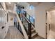 Bright hallway featuring an open staircase, wood flooring, and modern design at 6289 Redstone Hills Dr, Las Vegas, NV 89148