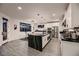 Gourmet kitchen with sleek countertops, modern appliances, and seamless flow to dining and living areas at 6289 Redstone Hills Dr, Las Vegas, NV 89148