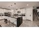 Elegant kitchen with white cabinets, marble countertops and breakfast bar at 6289 Redstone Hills Dr, Las Vegas, NV 89148