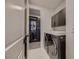 Well-organized laundry room with modern appliances and direct access to a walk-in closet at 6289 Redstone Hills Dr, Las Vegas, NV 89148