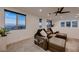 Relaxing living room with a comfortable couch, plants, and scenic views from the windows at 6289 Redstone Hills Dr, Las Vegas, NV 89148