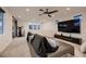 Spacious living room with a comfortable couch, mounted television, and ceiling fan at 6289 Redstone Hills Dr, Las Vegas, NV 89148