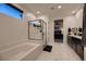 Modern main bathroom featuring a soaking tub, glass-enclosed shower, and stylish marble flooring at 6289 Redstone Hills Dr, Las Vegas, NV 89148