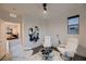 Bright sitting room with modern white chairs and unique artwork creates an inviting space at 6289 Redstone Hills Dr, Las Vegas, NV 89148