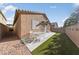 Backyard with patio, artificial turf, and a block wall at 6333 Supernova Hill St, North Las Vegas, NV 89031