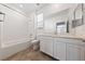 Bathroom with tub, toilet and vanity with mirror at 6333 Supernova Hill St, North Las Vegas, NV 89031