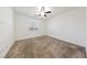 Spacious bedroom with neutral carpeting and a ceiling fan at 6333 Supernova Hill St, North Las Vegas, NV 89031