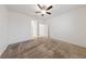 Spacious bedroom with ceiling fan and neutral carpeting at 6333 Supernova Hill St, North Las Vegas, NV 89031