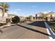 Gated community entrance with landscaping and paved road at 6333 Supernova Hill St, North Las Vegas, NV 89031