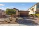 Single-story home with a two-car garage and well-manicured landscaping at 6333 Supernova Hill St, North Las Vegas, NV 89031