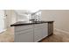 Kitchen island with granite countertop and stainless steel dishwasher at 6333 Supernova Hill St, North Las Vegas, NV 89031