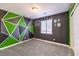 Stylish bedroom with green and gray accent wall at 6737 Fast Brook Ct, North Las Vegas, NV 89084