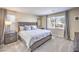 Main bedroom with large bed, nightstands, and plenty of natural light at 6737 Fast Brook Ct, North Las Vegas, NV 89084