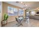 Modern dining room with glass table and gray chairs at 6737 Fast Brook Ct, North Las Vegas, NV 89084