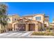 Two-story house with three-car garage, stone accents, and landscaping at 6737 Fast Brook Ct, North Las Vegas, NV 89084