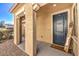 House entrance with covered porch, dark gray door, and welcome mat at 6737 Fast Brook Ct, North Las Vegas, NV 89084