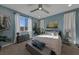 Relaxing bedroom with serene blue walls, soft carpet, and natural light at 7017 Solana Ridge Dr, North Las Vegas, NV 89084