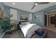 Calm blue bedroom featuring natural light, light grey carpet and modern décor at 7017 Solana Ridge Dr, North Las Vegas, NV 89084