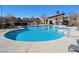 Community pool area featuring a large pool, lounge chairs, and clubhouse at 7017 Solana Ridge Dr, North Las Vegas, NV 89084