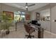 Functional home office with a glass desk, comfortable chair, and built-in shelving at 7017 Solana Ridge Dr, North Las Vegas, NV 89084