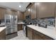 Modern kitchen featuring stainless steel appliances, mosaic backsplash, and a quartz countertop at 7017 Solana Ridge Dr, North Las Vegas, NV 89084