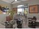 Home office showcasing a glass-top desk and ample natural light from the window at 7017 Solana Ridge Dr, North Las Vegas, NV 89084