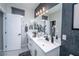 Double vanity bathroom with dark patterned wall at 724 Last Dance Pl, Henderson, NV 89011