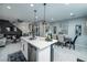 Open concept dining area with modern light fixtures and seating for six at 724 Last Dance Pl, Henderson, NV 89011