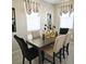 Dining room with dark wood table and neutral chairs at 724 Last Dance Pl, Henderson, NV 89011