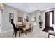 Bright dining room with wood table and six chairs, near entryway at 724 Last Dance Pl, Henderson, NV 89011