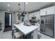 Modern kitchen with stainless steel appliances and island seating at 724 Last Dance Pl, Henderson, NV 89011