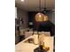 Kitchen island with modern pendant lights and breakfast bar at 724 Last Dance Pl, Henderson, NV 89011