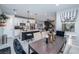 Modern kitchen with island, white cabinets, and dining area at 724 Last Dance Pl, Henderson, NV 89011