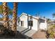 Bright backyard with spacious patio, and two palm trees at 7305 Backstretch Ave, Las Vegas, NV 89130