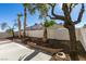 Landscaped backyard with patio and mature trees at 7305 Backstretch Ave, Las Vegas, NV 89130