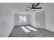 Well-lit bedroom, ceiling fan, and carpet flooring at 7305 Backstretch Ave, Las Vegas, NV 89130